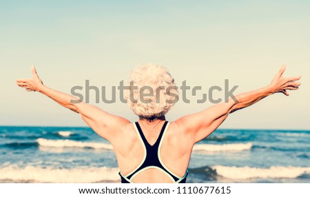 Mature Asian woman stretching out her arms