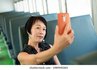 Mature Asian Woman Take A Selfie At A Carriage Of Train