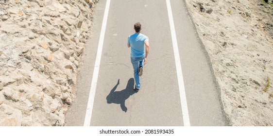 Mature Athletic Guy Running On Road Outdoor, Back View, Jogging