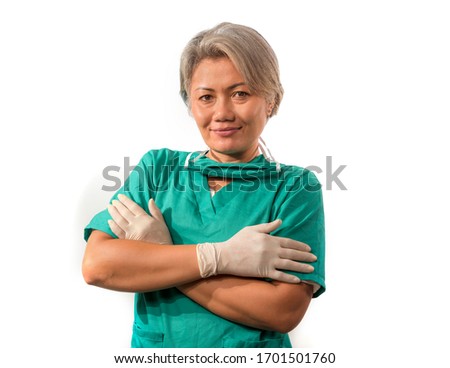 mature attractive and happy medicine doctor woman or experienced hospital nurse in medical scrubs in face mask with hands in latex gloves confident and cheerful
