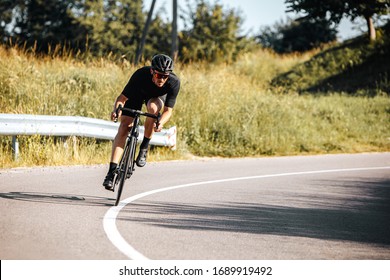 Mature bearded cyclist in sport outfit and protective helmet riding bicycle on fresh air. Sportsman leading active lifestyle with green nature around. - Powered by Shutterstock