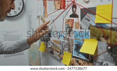 A mature, bearded man analyzes clues on a corkboard inside a detective's office, indicating a complex investigation.
