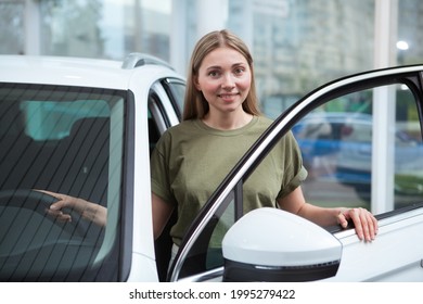 Mature Beautiful Woman Getting Out Of The New Auto At Car Dealership