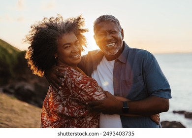 Mature black couple embracing and sharing a loving moment outdoors at sunset, radiating happiness and connection. Showcasing a blissful retirement.