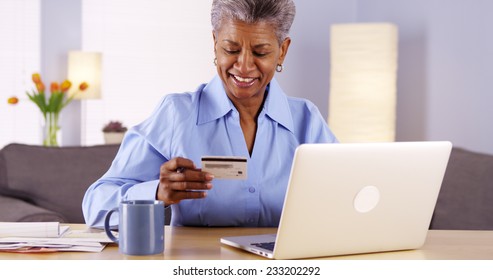 Mature Black Woman Happily Paying Her Bills