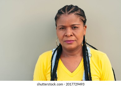 Mature Black Woman Outside The City, Looking At The Camera Serious.