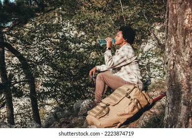 Mature Black Woman Taking A Water Break During Hike In The Mountains.