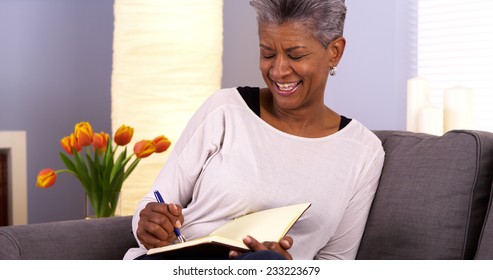 Mature Black Woman Writing In Journal