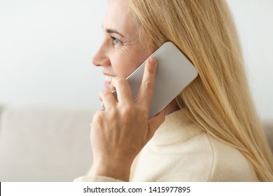 Mature Blond Woman Talking On Phone, Closeup, Side View