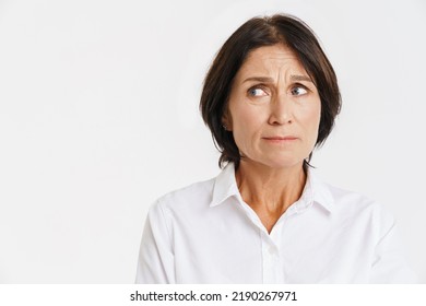 Mature brunette woman frowning and looking aside isolated over white background - Shutterstock ID 2190267971