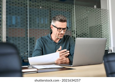Mature business man executive coach talking using laptop computer having video conference call virtual meeting, professional training negotiation remote working doing online presentation in office. - Shutterstock ID 2021634257