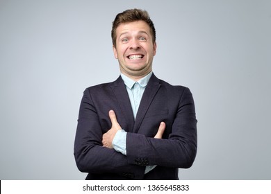 Mature business man laughs from ear to ear, giggles on the funny stories. False or fake smile. - Shutterstock ID 1365645833