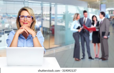 Mature Business Woman With Computer And Group Of People.