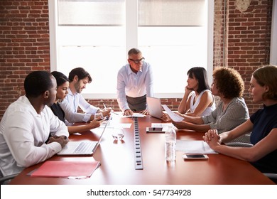 Mature Businessman Addressing Boardroom Meeting