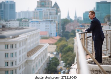 Mature businessman enjoying city view from the rooftop