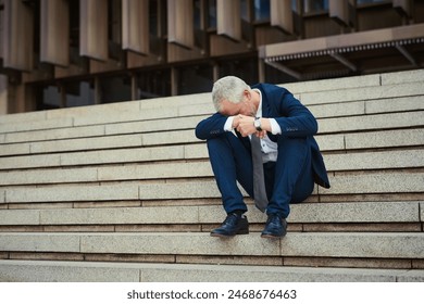 Mature, businessman and frustrated on steps in city for financial, career and headache from tax. Debt, corporate and accountant on stairs in New York for stock market, stress and anxiety for economy - Powered by Shutterstock