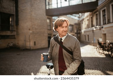 Mature businessman having a cup of coffee in the morning while commuting to work with a bicycle - Powered by Shutterstock