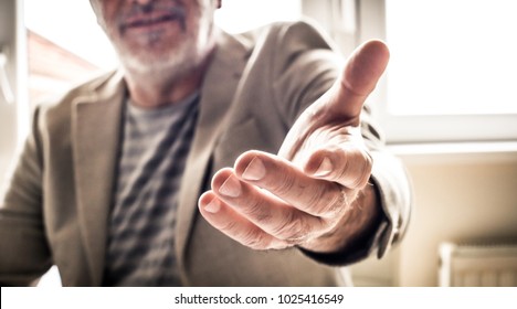 Mature Businessman Helping Hand. Close Up. 