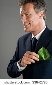 Mature Businessman Hold A Green Leaf In His Suit Pocket. Green Business Concept, Take Care Of The Environment!