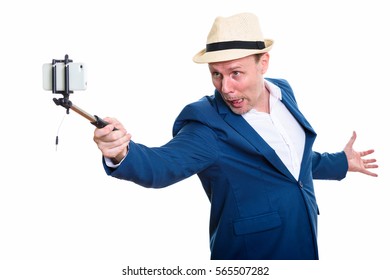 Mature Businessman Holding Selfie Stick And Taking Selfie Picture With Mobile Phone While Making Funny Face