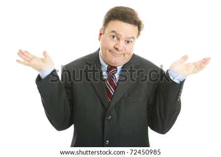 Mature businessman shrugs in an indifferent way.  Isolated on white.
