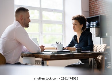 Mature Businesswoman Taking An Interview Of Man Over The Wooden Desk In Office - Shutterstock ID 2161474013