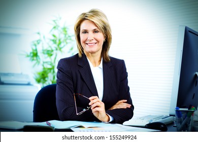 Mature Bussiness Woman Sitting In Office