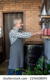 Mature Cafe Owner Working In His Establishment