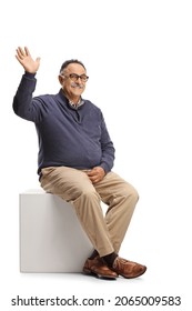 Mature Casual Man Sitting And Waving At Camera Isolated On White Background