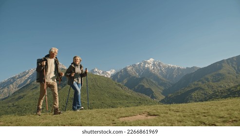Mature caucasian couple on vacation, having a hike in spring mountains, spending time together after retirement together travelling - tourism, pension concept - Powered by Shutterstock