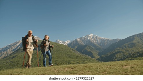 Mature caucasian couple on vacation, having a hike in spring mountains, spending time together after retirement together travelling - tourism, pension concept - Powered by Shutterstock