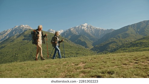 Mature caucasian couple on vacation, having a hike in spring mountains, spending time together after retirement together travelling - tourism, pension concept - Powered by Shutterstock