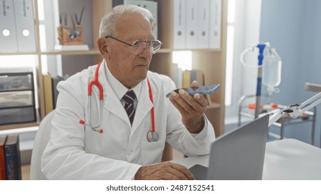 Mature caucasian grey-haired man, dressed as a doctor, working in a hospital room using a laptop and speaking into a phone - Powered by Shutterstock