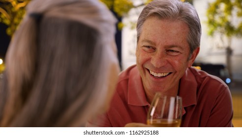 Mature Caucasian male chats with female at restaurant over wine - Powered by Shutterstock