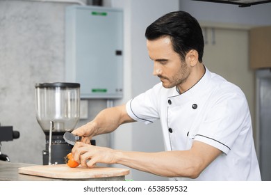 Mature Chef In Kitchen Cooking Dish For Dinner, 30-40 Year Old.