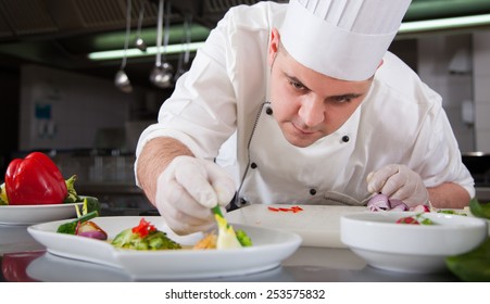 mature chef preparing a meal with various vegetables - Powered by Shutterstock