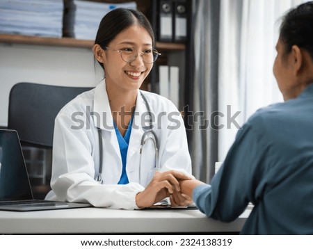 Mature chinese woman in consultation with a doctor with abdominal pain. depression.