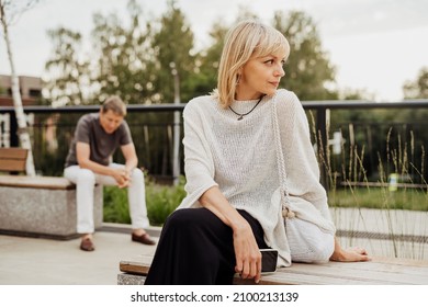 Mature Couple In A Bad Mental Condition After A Quarrel Outdoors. Adult Couple Man And Woman Trying To Overcome Anxiety And Disorder After A Break-up Scene.