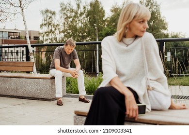 Mature Couple In A Bad Mental Condition After A Quarrel Outdoors. Adult Couple Man And Woman Trying To Overcome Anxiety And Disorder After A Break-up Scene.