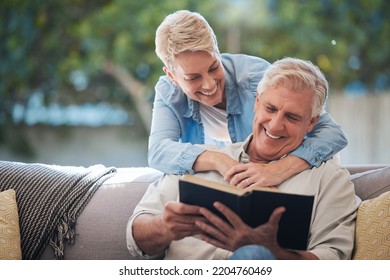 Mature couple, bond and funny book on house or home sofa in garden and backyard patio. Smile, happy or relax senior man and elderly woman in retirement hug, trust or security love marriage with novel