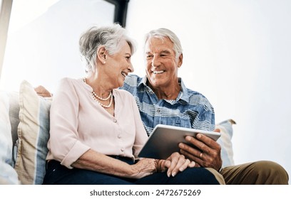 Mature couple, browsing and tablet in living room in house with online funny movie streaming on website. Laughing, subscription and people in home with networking, social media and app in retirement. - Powered by Shutterstock