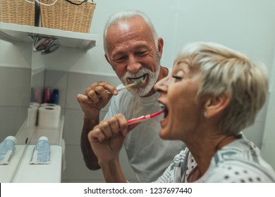 Mature Couple Brushing Teeth