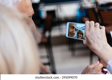 Mature Couple In Cafe Taking Selfie Using Smart Phone