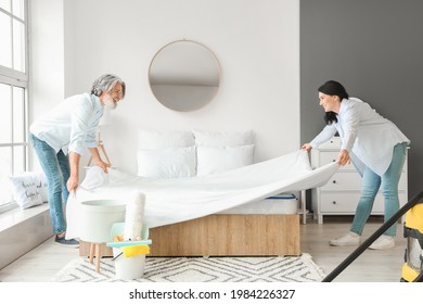 Mature Couple Cleaning Their Bedroom