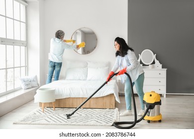 Mature Couple Cleaning Their Bedroom