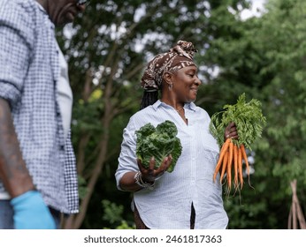 Mature couple collecting vegetables in allotment - Powered by Shutterstock