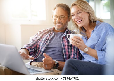 Mature Couple Connected On Internet With Laptop