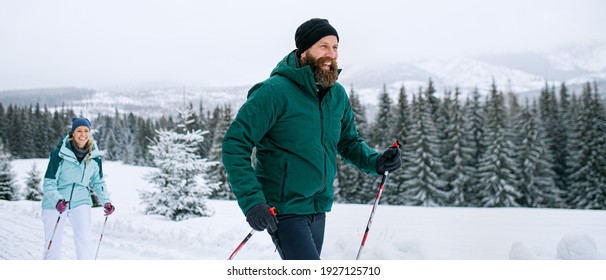 Mature Couple Cross Country Skiing Outdoors In Winter Nature, Tatra Mountains Slovakia.