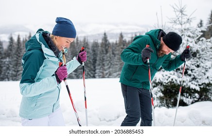 Mature Couple Cross Country Skiing Outdoors In Winter Nature, Tatra Mountains Slovakia.