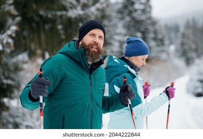 Mature Couple Cross Country Skiing Outdoors In Winter Nature, Tatra Mountains Slovakia.